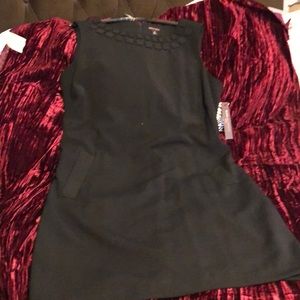 Dana Buchman black lined dressy dress size 16 with neck ornan. And pockets .